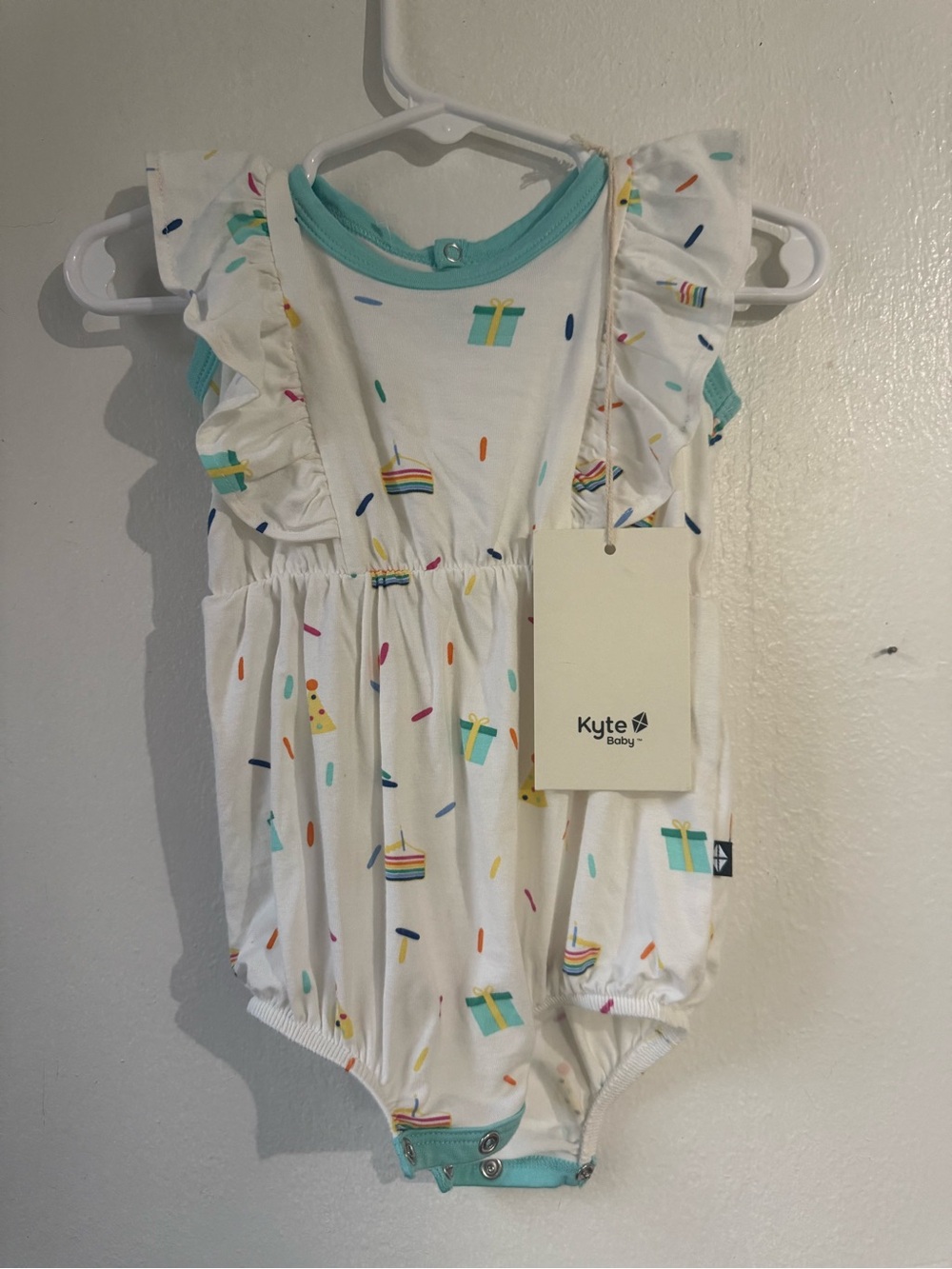Kyte BABY White Romper with Teal Trim and Colorful Sprinkles